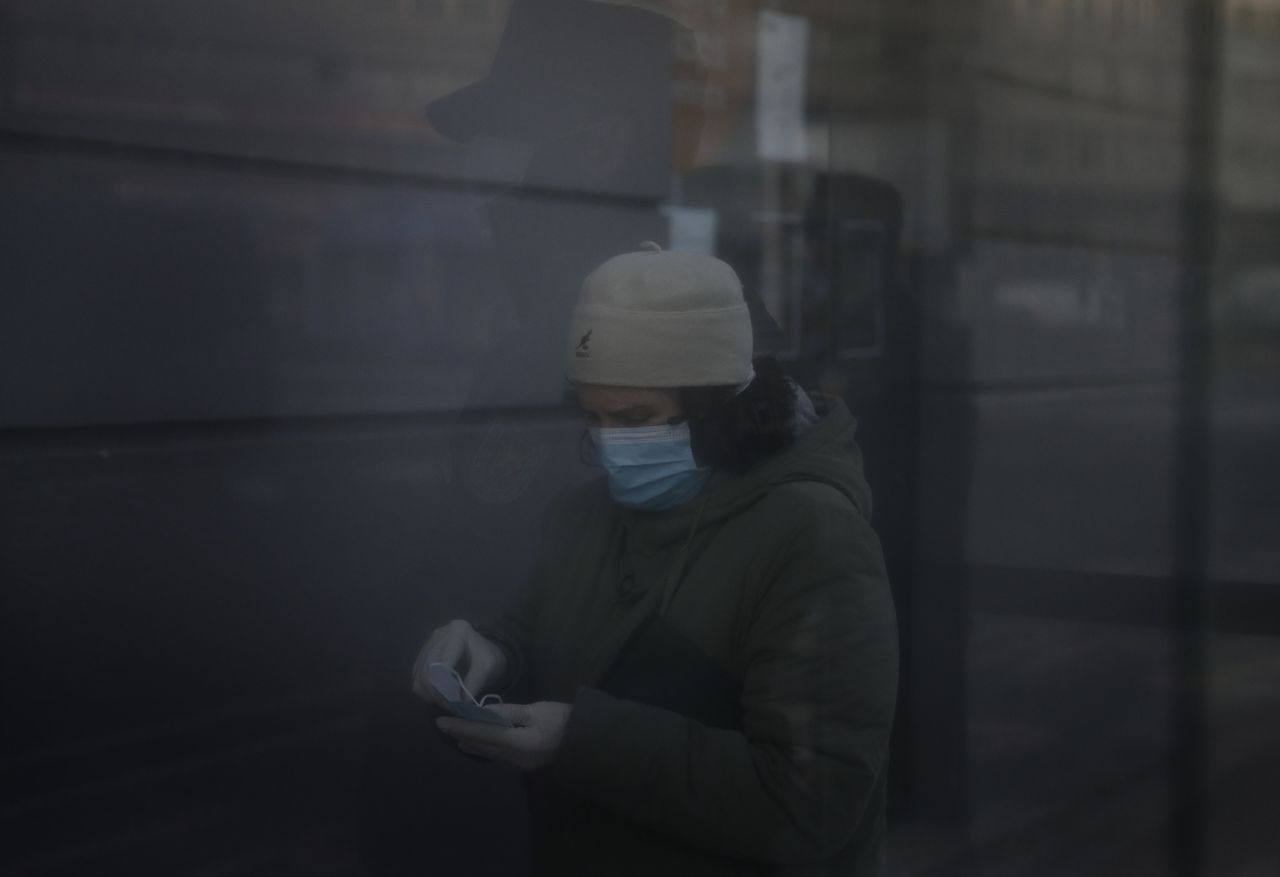 Una mujer se guarda una segunda mascarilla durante el primer d�a de reparto a la poblaci�n