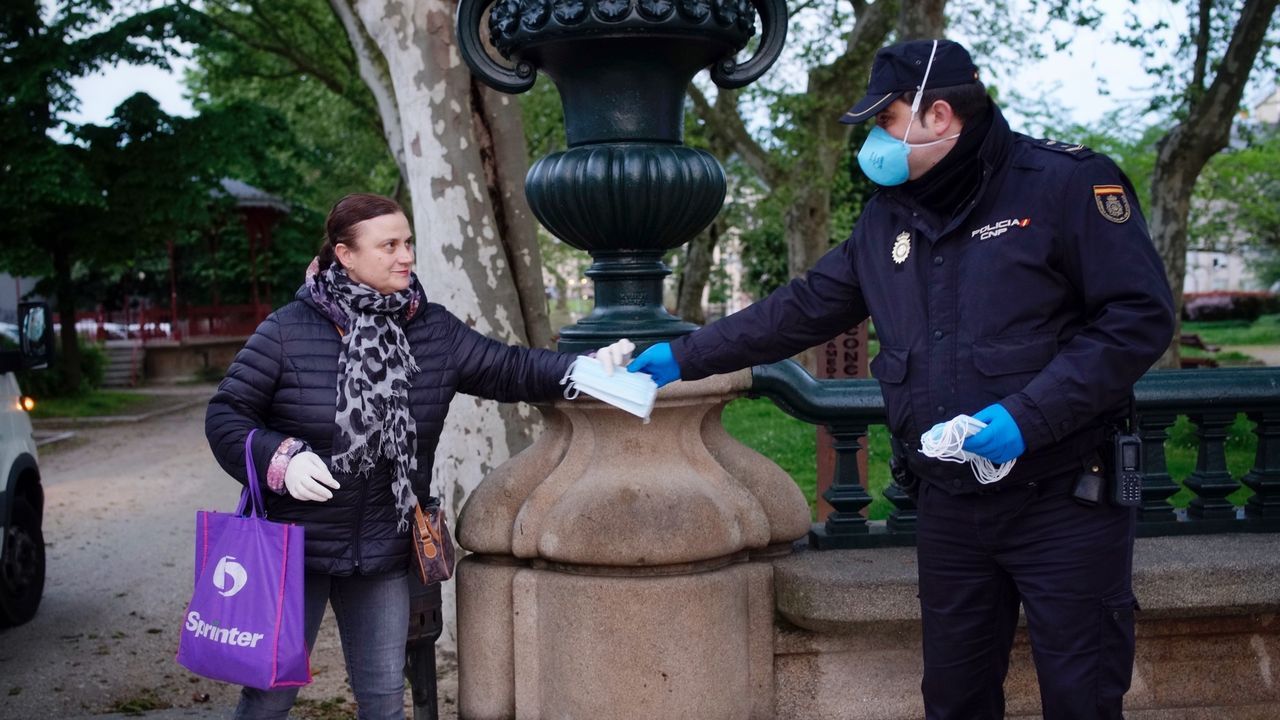 La Policía Nacional reparten mascarillas a usuarios del autobús en Ourense