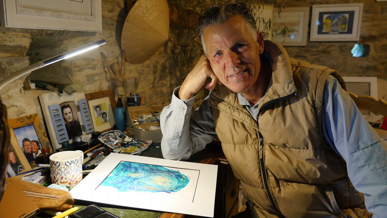 .Arthur en su mesa de trabajo, donde pinta. Hizo el Camino en 2006, se enamoró de la ruta y compró un galpón que rehabilitó como galería y vivienda en A Balsa, Triacastela
