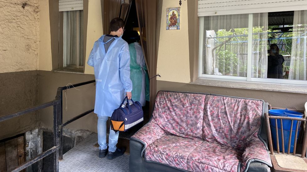 La vacunación a domicilio en el rural.La médico y el enfermero de O Bolo entrando en uno de los domicilios de su ruta del martes